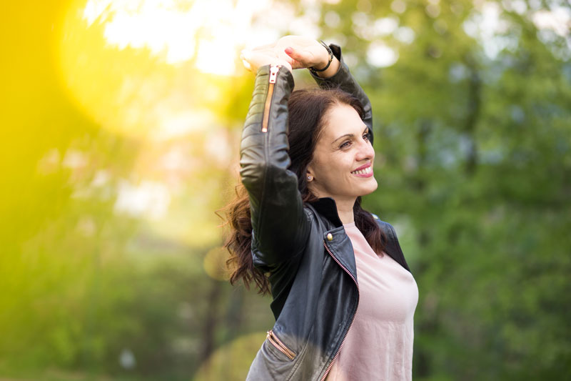 Woman smiling holding up arms